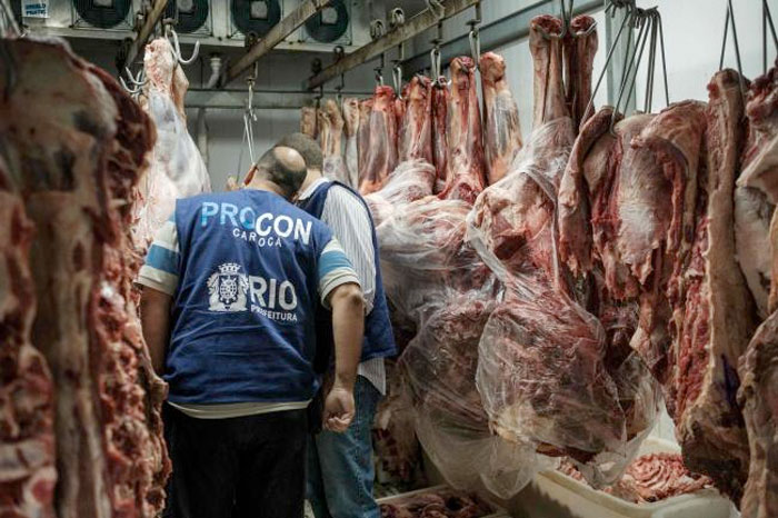 The staff of Rio de Janeiro state's consumer protection agency, PROCON, inspect meat products in the cold storage room at a supermarket in Rio de Janeiro, Brazil. — AFP