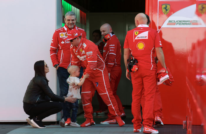 Ferrari's Kimi Raikkonen holds his son Robin Raikkonen next to his wife Minttu Virtanen in the paddock in Catalunya Friday. — Reuters