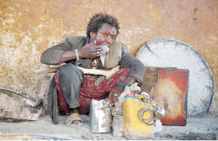 An internally displaced Somali man eats a maize meal from the United Nations World Food Programme (WFP) feeding program at the Sorrdo camp in Hodan district of Somalia’s capital Mogadishu. — Reuters