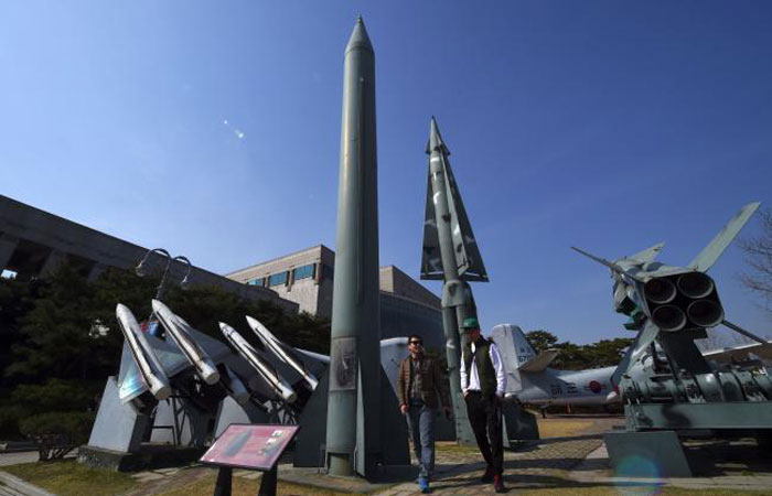 Visitors walk past replicas of a North Korean Scud-B missile, center, and South Korean Nike missiles, right, at the Korean War Memorial in Seoul on Wednesday. — AFP