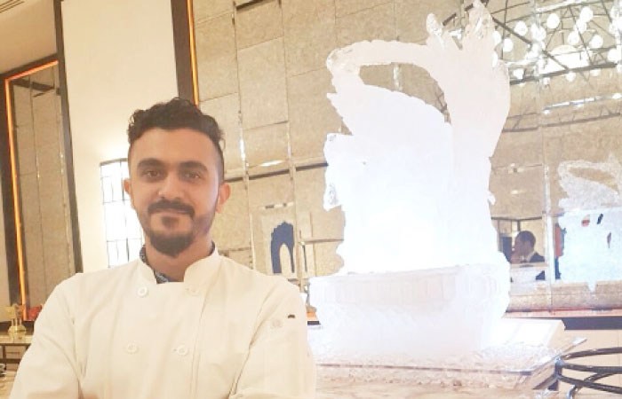Mohammed Abutalib poses with one of his ice sculptures.