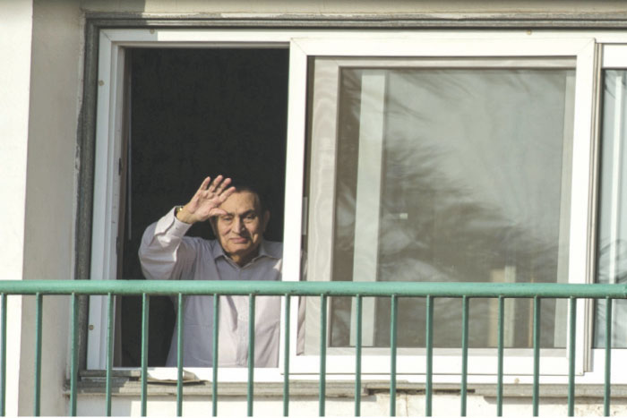 This file photo taken on Oct. 6, 2016, shows Egypt’s former president Hosni Mubarak waving to people from his room at the Maadi military hospital in Cairo. — AFP