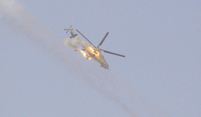 An Army helicopter fires its weapons as Iraqi forces battle with Daesh militants in western Mosul on Sunday. — Reuters