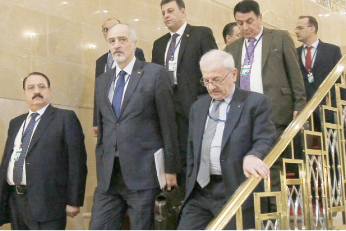 Syria’s UN ambassador and head of the government delegation Bashar Al-Jaafari (2nd left), Syrian Ambassador to Russia Riad Haddad (left) and other delegates arrive to attend the third round of Syria peace talks at the Rixos President Hotel in Astana, Wednesday. — AFP