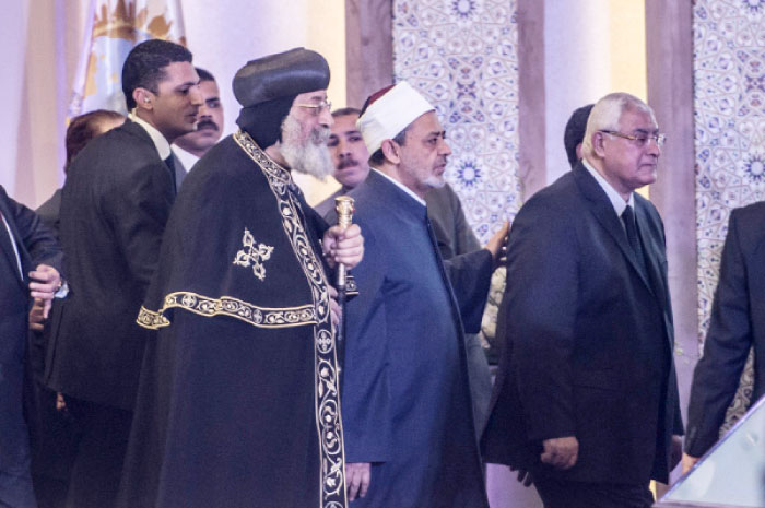 Egypt’s Grand Imam of Al-Azhar Sheikh Ahmed Mohamed Al-Tayeb (center) Egypt’s former interim president Adly Mansour (right), and leader of Egypt’s Coptic Church, Pope Tawadros II (left) of Alexandria arrive to attend a conference titled “Freedom and citizenship’’ hosted by Al-Azhar in Cairo, Tuesday. — AFP