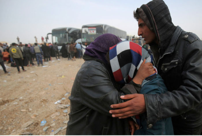 An Iraqi woman displaced from the city of Mosul is hugged by her relatives as she re-unites with her family following her arrival at a camp in the Hamam Al-Alil area south of the embattled city. — AFP