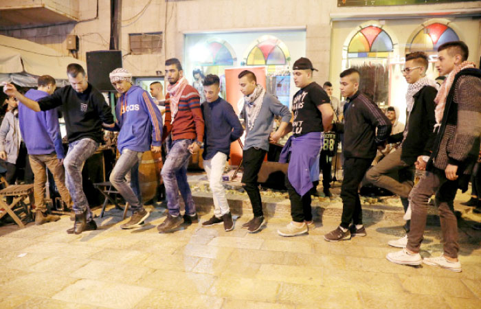 Palestinian men dance to Arabic Debke music during a backgammon championship organized by Double Yerushalmi, a group trying to build closer ties between Arabs and Jews through cultural activities, in occupied Jerusalem. — Reuters