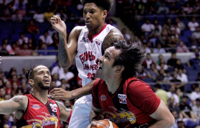 San Miguel Beer's June Mar Fajardo gets ready to shoot the ball as Ginebra's Joe Devance defends in Game 3 of the PBA Philippine Cup Finals at the Smart-Araneta Coliseum Wednesday night.