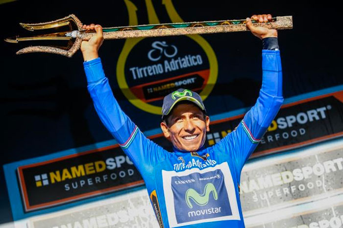 Colombian cyclist Nairo Quintana celebrates by lifting the winner’s trident on the Tirreno Adriatico cycling race podium.