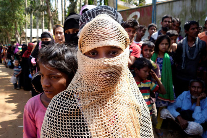 A Rohingya refugee woman waits in line to collect food at Balu Kali Refugee Camp in Cox’s Bazar, Bangladesh, in this March 2, 2017 file photo. — Reuters
