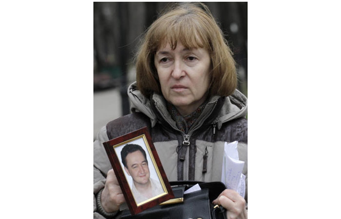 Nataliya Magnitskaya, mother of Sergei Magnitsky who died in jail, holds a photo of her son as she speaks during an interview in Moscow in this Nov. 30, 2009 file photo. — AP