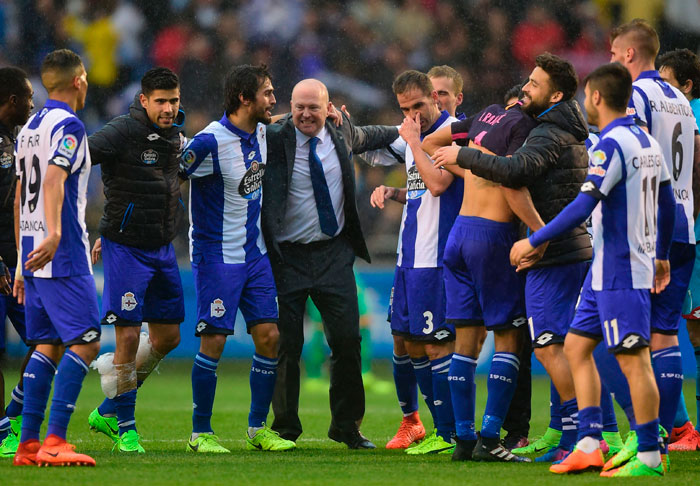 Deportivo La Coruna's coach Pepe Mel (C) celebrates with his players at the end of the Spanish league football match against Barcelona at the Municipal de Riazor Stadium in La Coruna Sunday. — AFP