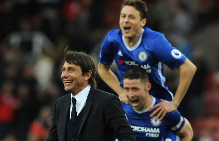 Chelsea manager Antonio Conte and players celebrate after Chelsea beat Stoke City during the English Premier League soccer match at the Britannia Stadium, Stoke, Saturday. — AP