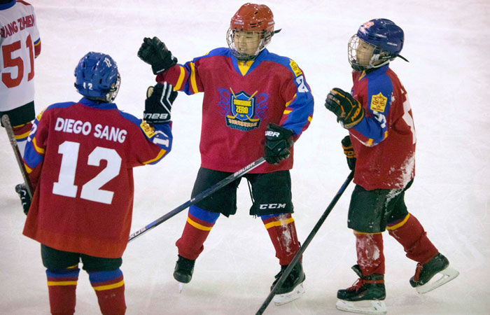 In this Saturday, Feb. 18, 2017, photo, Chinese players high-five each other during a youth ice hockey tournament in Beijing. The NHL sees China as hockey’s next great frontier. — AP