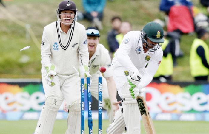 South Africa’s Quentin de Kock (R) is out bowled as New Zealand’s BJ Watling celebrates during day four of the first cricket Test at University Oval, Dunedin, Saturday. — AP