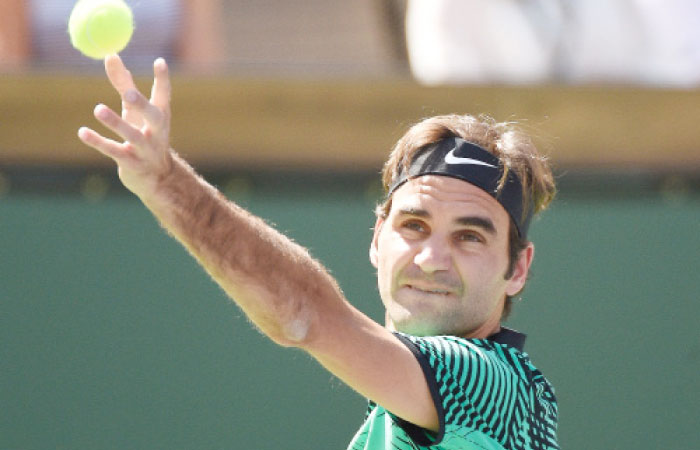 Roger Federer of Switzerland serves against Jack Sock of the US during their semifinal match of the BNP Paribas Open at Indian Wells Saturday. — AFP