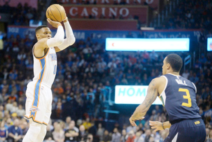 Oklahoma City Thunder’s guard Russell Westbrook shoots a 3-point shot over Utah Jazz guard George Hill during the second quarter at Chesapeake Energy Arena in Oklahoma City Saturday. — AP