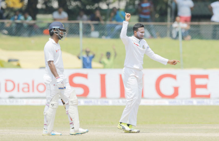 Bangladesh bowler Shakib Al Hasan (R) celebrates the dismissal of Sri Lanka’s Asela Gunaratne on day four of the second Test cricket match in Colombo Saturday. — AP