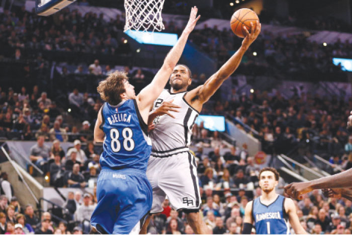 San Antonio Spurs’ small forward Kawhi Leonard shoots around Minnesota Timberwolves’ power forward Nemanja Bjelica during their NBA game at AT&T Center in San Antonio Saturday. — Reuters