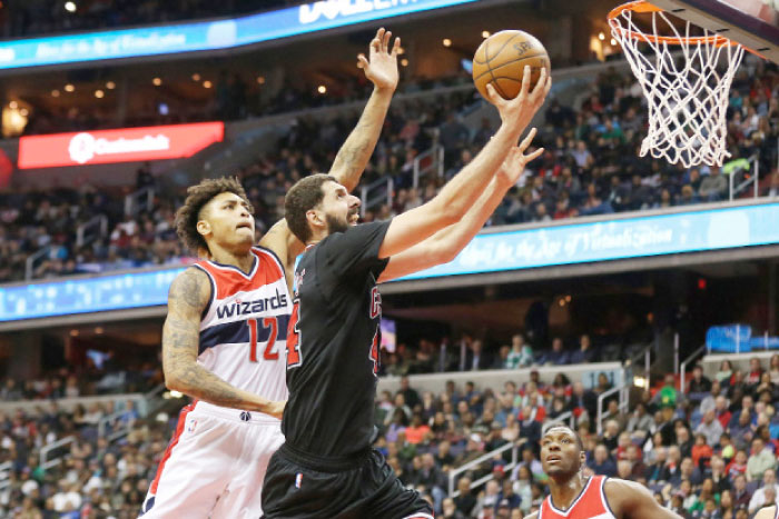 Chicago Bulls’ forward Nikola Mirotic shoots the ball as Washington Wizards’ forward Kelly Oubre Jr. defends during their NBA game at Verizon Center in Washington Friday. — Reuters