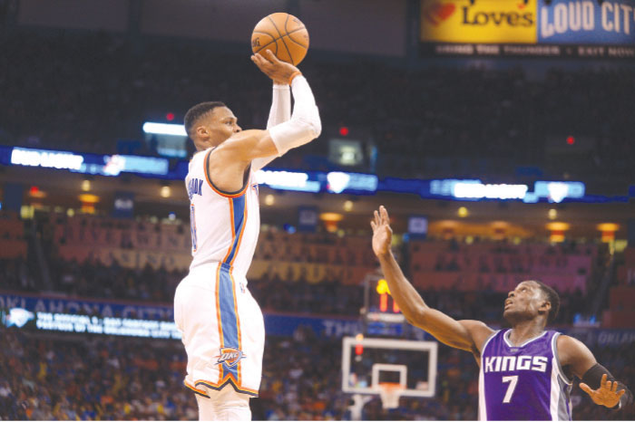 Oklahoma City Thunder’s guard Russell Westbrook shoots the ball over Sacramento Kings’ guard Darren Collison during their NBA game at Chesapeake Energy Arena in Oklahoma City Saturday. — Reuters