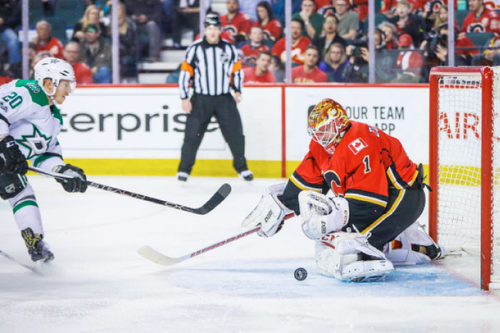 Calgary Flames’ goalie Brian Elliott (R) makes a save as Dallas Stars’ center Cody Eakin tries to score during their NHL game at Scotiabank Saddledome in Calgary Friday. — Reuters