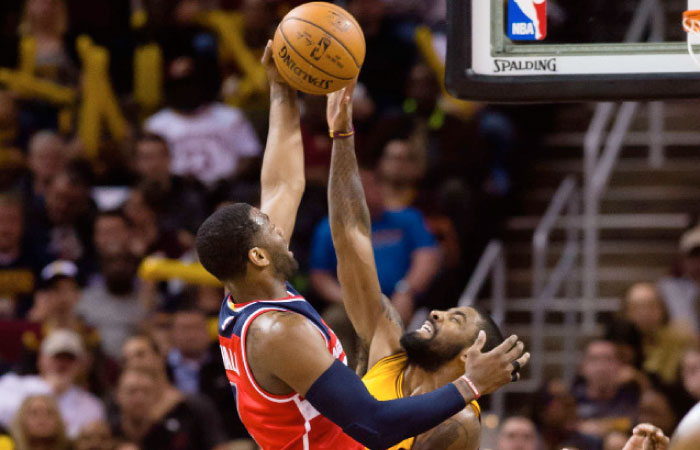 John Wall (L) of the Washington Wizards shoots over Kyrie Irving of the Cleveland Cavaliers during their NBA game at Quicken Loans Arena in Cleveland Saturday. — AFP