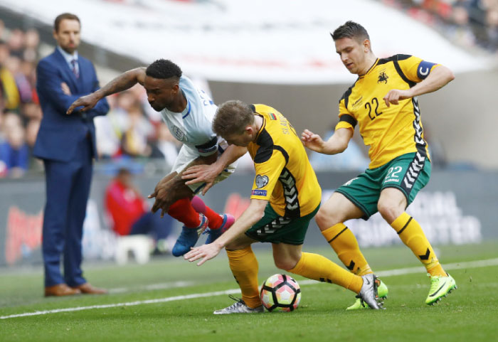 England's Jermain Defoe in action with Lithuania's Vaidas Slavickas and Lithuania's Fedor Chernykh chasing him during the World Cup Qualifying European Zone Group F match at Wembley Stadium, London. — Reuters