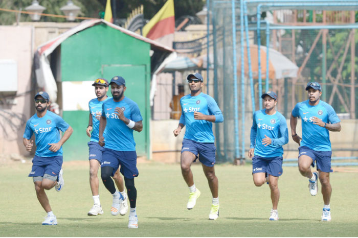 Indian cricketers jog as they warm up during a practice session at the M. Chinnaswamy Stadium in Bangalore Wednesday. — AFP