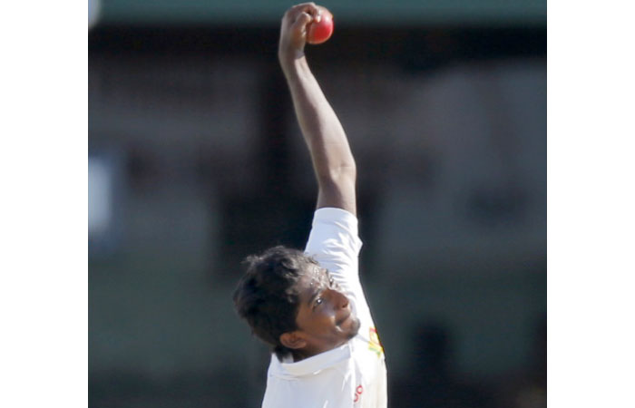 Sri Lanka’s bowler Lakshan Sandakan delivers a ball against Bangladesh on day two of their second Test cricket match in Colombo Thursday. — AP
