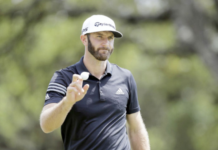 Dustin Johnson waves to the gallery after making a putt on the sixth hole at the Dell Technologies Match Play Golf Tournament at Austin County Club in Austin Wednesday. — AP