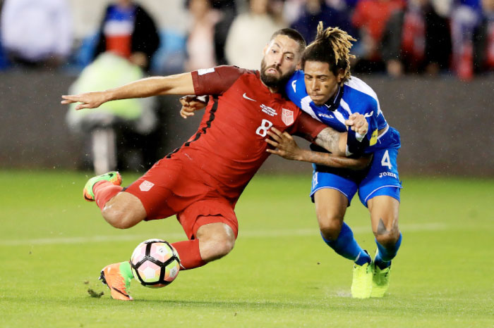Clint Dempsey (L) of the US scores a goal as Henry Figueroa of Honduras defends during their FIFA 2018 World Cup qualifier at Avaya Stadium in San Jose Friday. — AFP