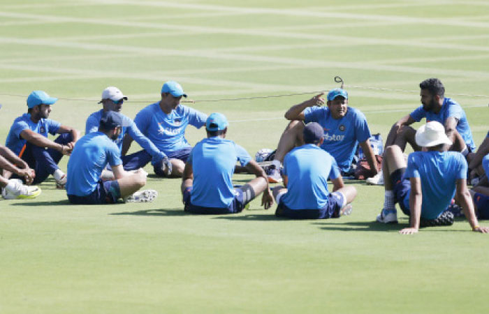 Members of the Indian cricket team listen to team coach Anil Kumble (C facing camera), before attending a training session in Bangalore Friday. — AP