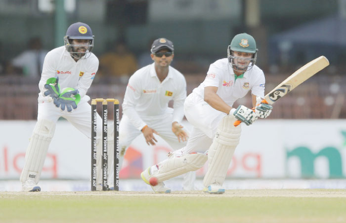 Bangladeshi batsman Shakib Al Hasan plays a shot as Sri Lanka’s Niroshan Dickwella watches on day three of their second Test cricket match in Colombo Friday. — AP
