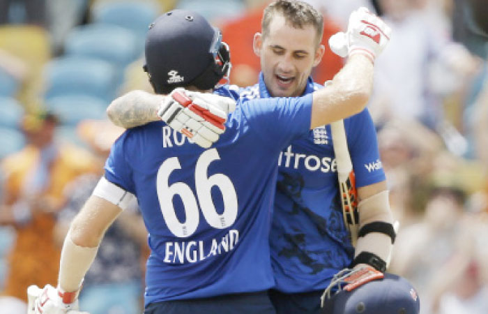 England’s Alex Hales (R) is embraced by teammate Joe Root after he scored a century against West Indies during their third One-Day International cricket match at the Kensington Oval in Bridgetown, Barbados, Thursday. — AP