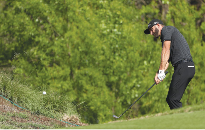 Dustin Johnson plays a shot on the 14th hole at the World Golf Championships in Austin, Texas, Friday. — AFP