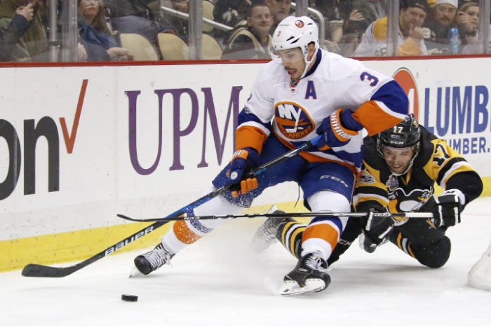 Pittsburgh Penguins’ Bryan Rust (R) collides with New York Islanders’ Travis Hamonic during their NHL game in Pittsburgh Friday. — AP