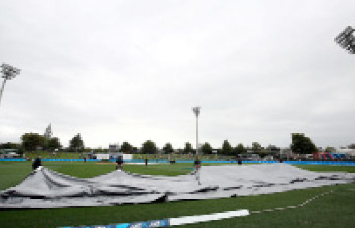 The grounds taff pull the covers onto the field in Hamilton. — AFP