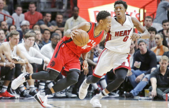 Toronto Raptors’ guard DeMar DeRozan drives to the basket past Miami Heat’s Josh Richardson during their NBA game in Miami Thursday. — AP