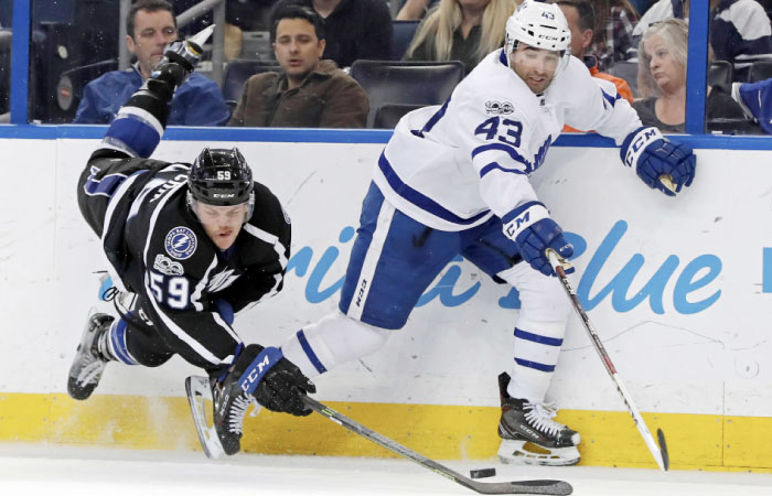 Jake Dotchin (L) of the Tampa Bay Lightning tries to check Nazem Kadri of the Toronto Maple Leafs during their NHL game at the Amalie Arena in Tampa, Florida, Thursday. — AFP