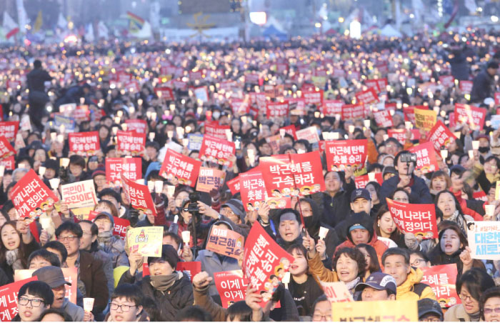 Protesters stage a candle light vigil calling for impeached President Park Geun-Hye’s arrest in Seoul, South Korea, on Saturday. — AP