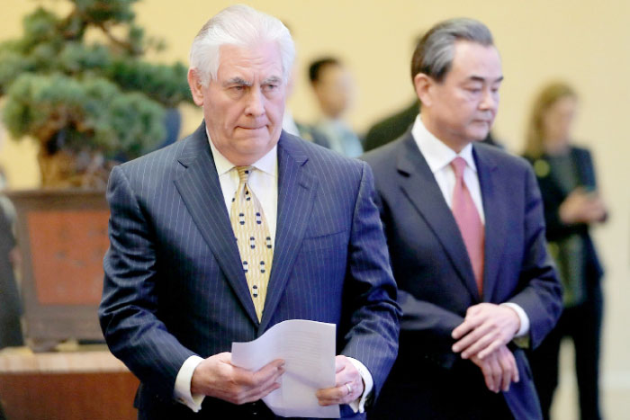 Chinese Foreign Minister Wang Yi, right, and US Secretary of State Rex Tillerson, left, arrrive for a joint press conference at Diaoyutai State Guesthouse in Beijing on Saturday. — Reuters