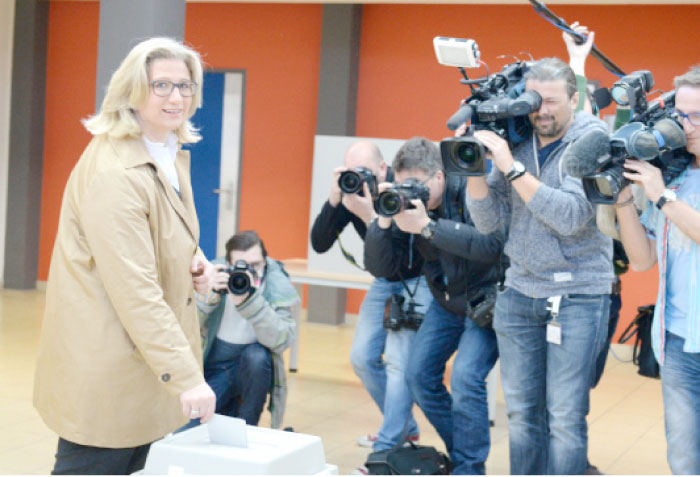 Anke Rehlinger, left, top candidate of the social democratic party (SPD) for the state election in the German federal state of Saarland, casts her ballot at a polling station in Nunkirchen, south-western Germany, on Sunday. — AFP