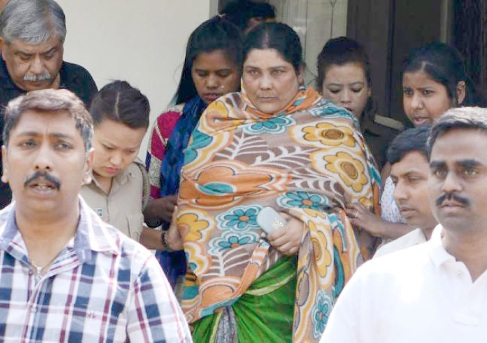Indian Crime Investigation Department (CID) officials escort Chandana Chakraborty from CID office in Siliguri on Saturday for an appearance at a court in Jalpaiguri in the eastern Indian state of West Bengal. — AFP