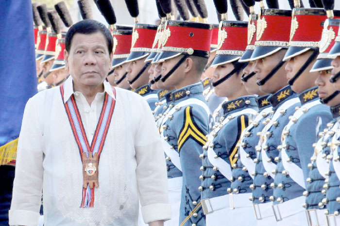 Philippine President Rodrigo Duterte walks past cadets to attend graduation ceremonies at the Philippine Military Academy in Baguio city, in northern Philippines, on Sunday. — Reuters