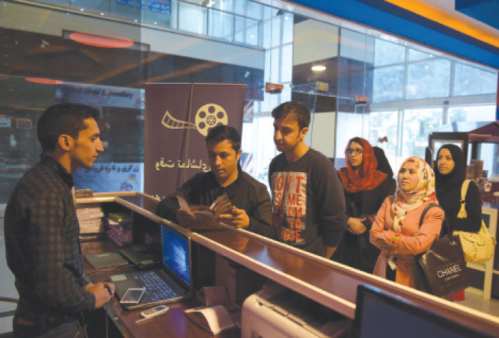 An Afghan family queue to buy tickets at the Galaxy Family Cinema in Kabul. A family-friendly cinema has opened in Kabul, creating a rare venue in Afghanistan’s war-torn capital where women, usually confined to the home, can spend time in public with their husbands and children. — AFP