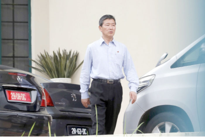 Ri Tong Il, former North Korean deputy ambassador to the United Nations, walks toward a car inside North Korean Embassy in Kuala Lumpur, Malaysia, on Sunday. — AP