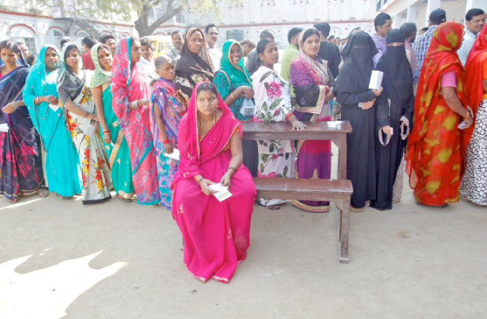 People queue up to vote at a polling booth during the last phase of Uttar Pradesh state assembly election, in Varanasi, India, on Wednesday. — Reuters