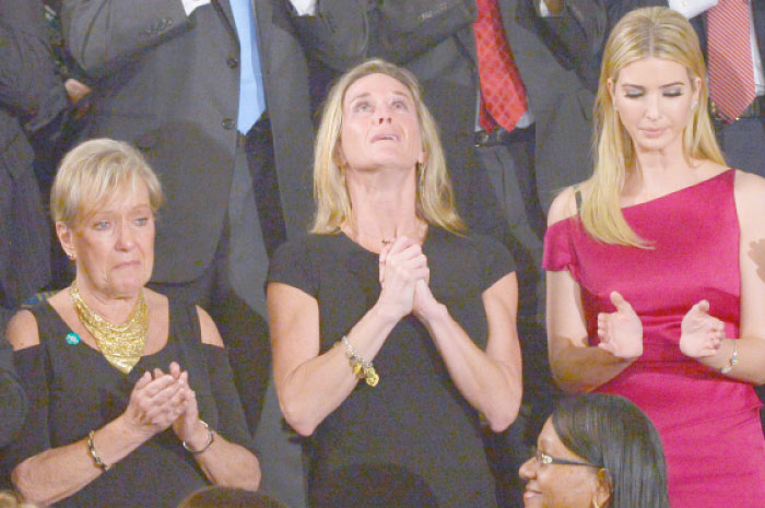 Carryn Owens, the wife of slain Navy SEAL William ‘Ryan’ Owens, looks up while being acknowledged by US President Donald Trump during his address to a joint session of Congress at the US Capitol in Washington, D.C., on Tuesday. — AFP