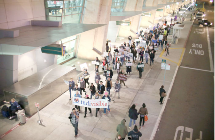 Protesters chant during a rally against the travel ban at San Diego International Airport in San Diego, California, on Monday. — AFP